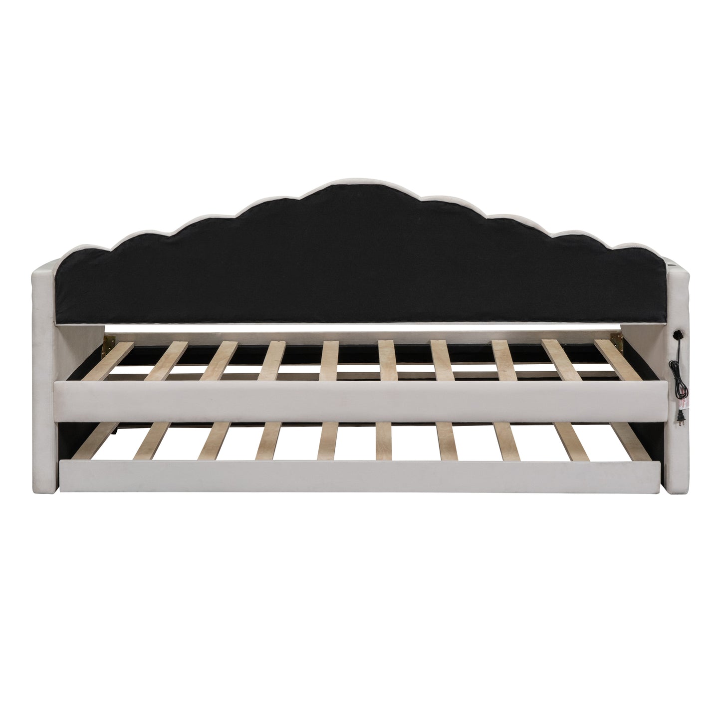 Ivory upholstered daybed with scalloped headboard and visible wooden slats