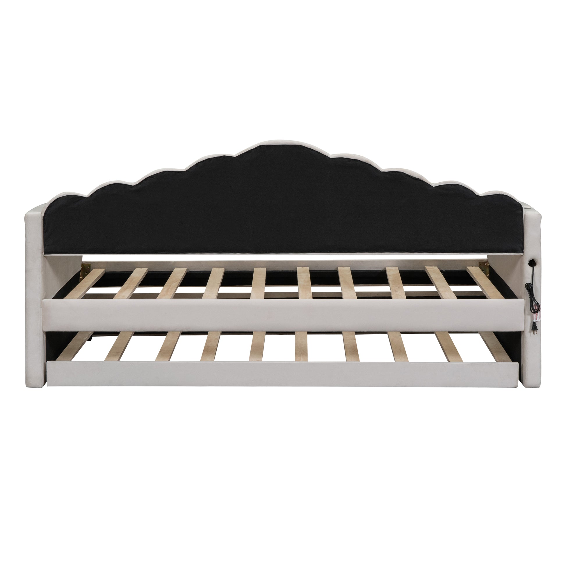 Ivory upholstered daybed with scalloped headboard and visible wooden slats