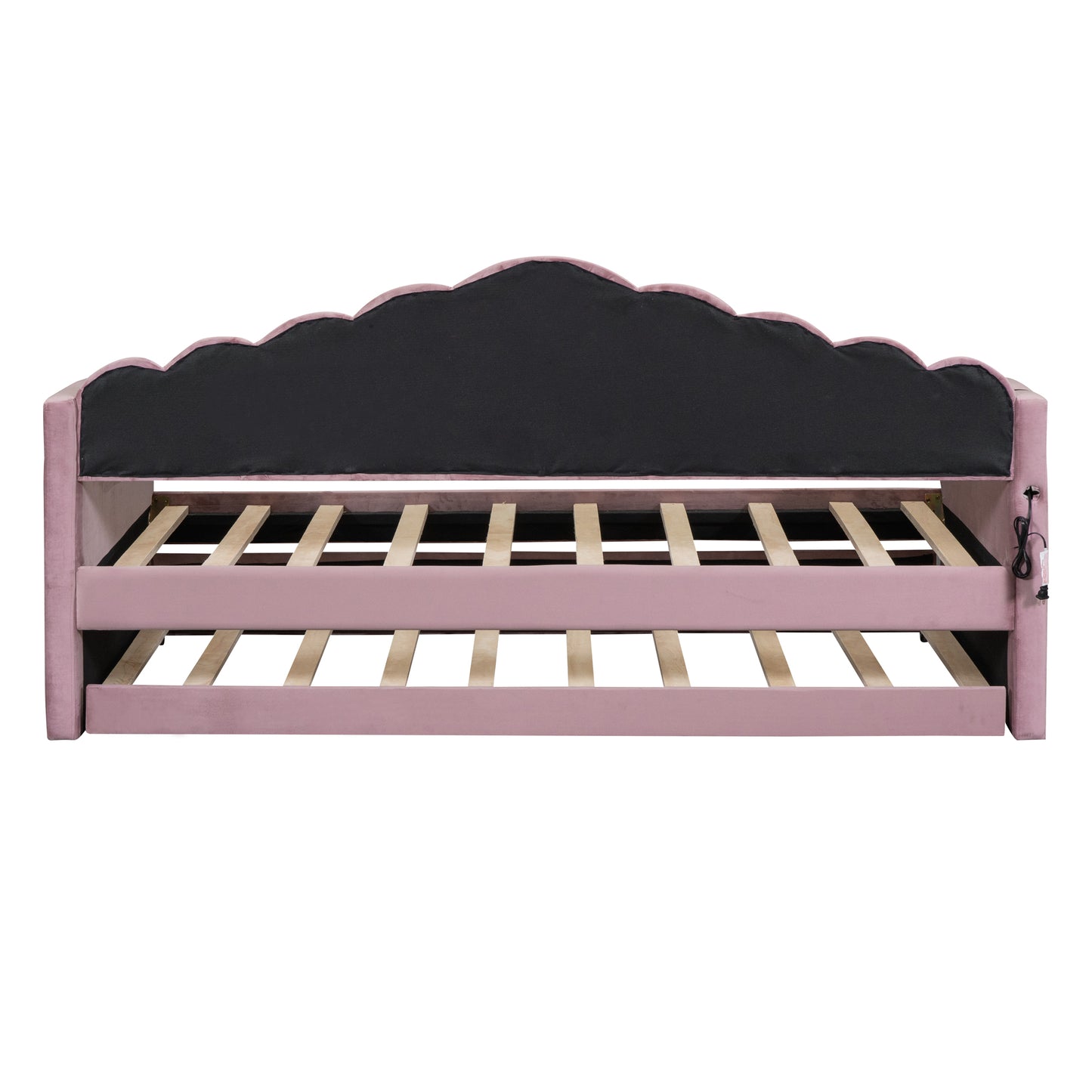 Pink velvet daybed with scalloped headboard and wooden slats