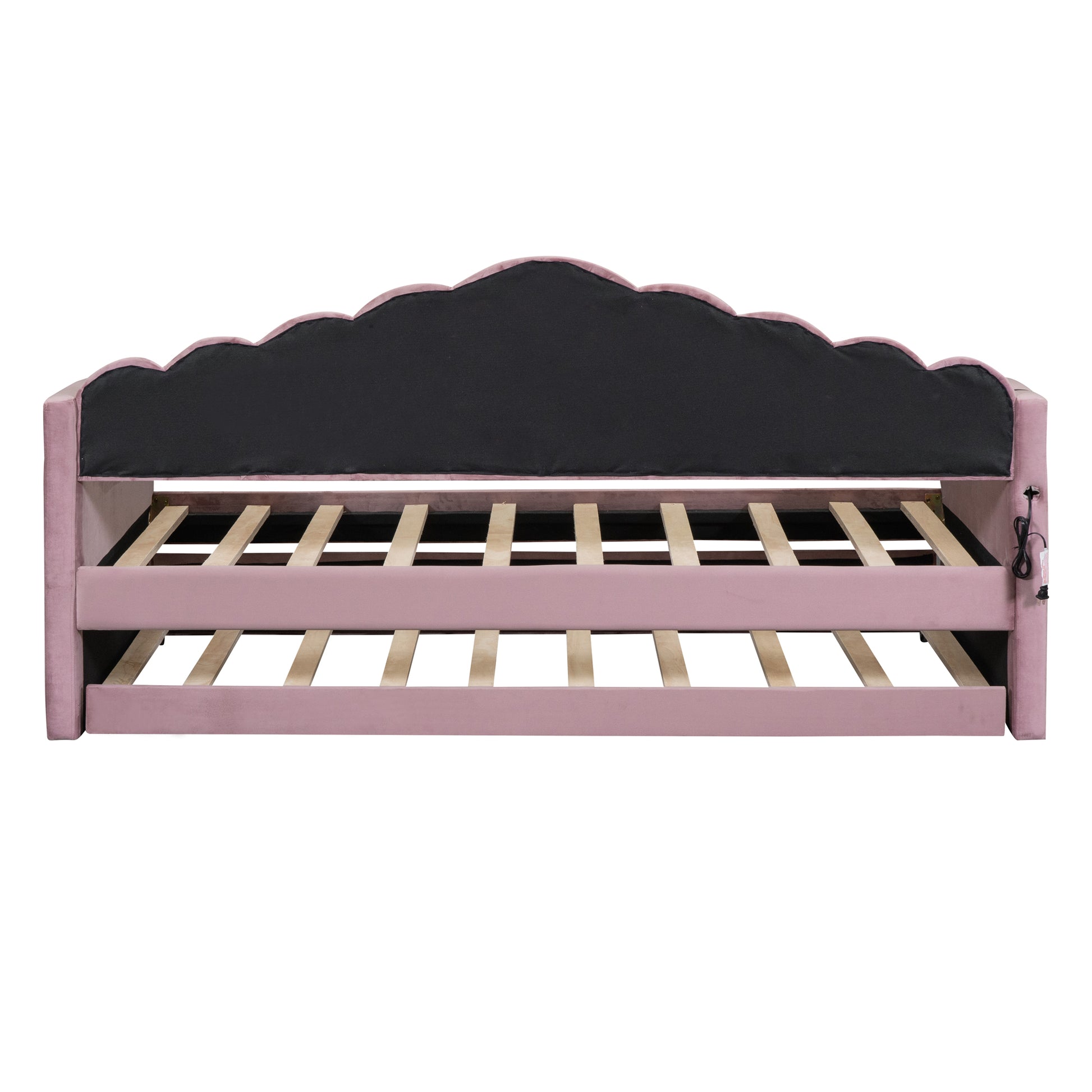 Pink velvet daybed with scalloped headboard and wooden slats