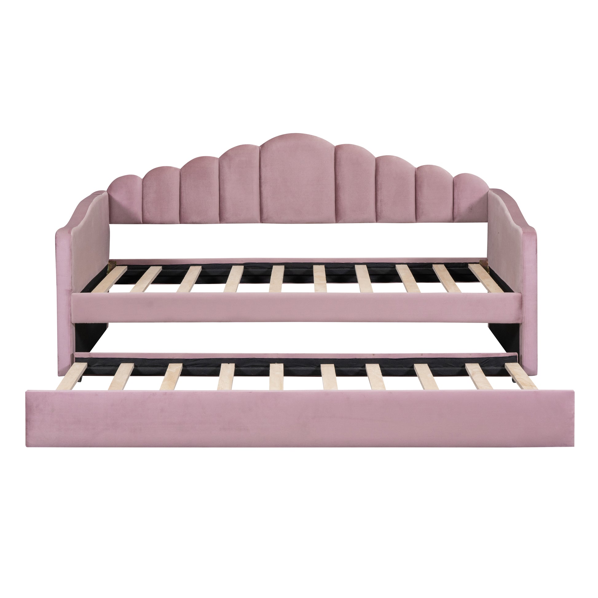 Pink velvet daybed with scalloped headboard and pullout trundle