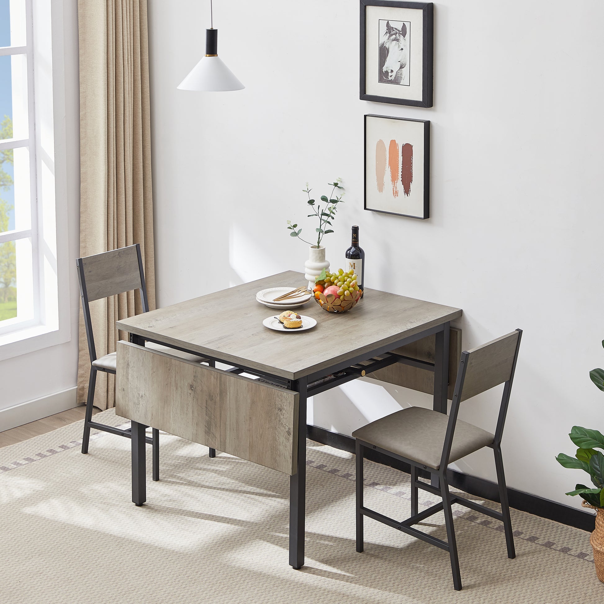 Compact dropleaf dining table with light oak finish and gray chairs