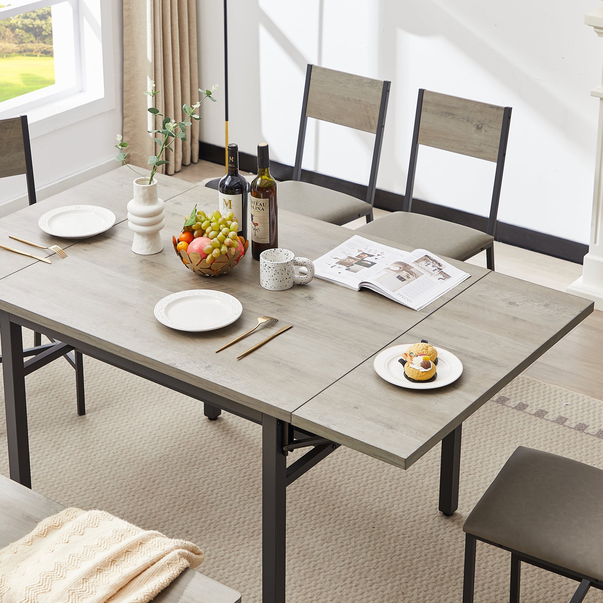 Grey wash wood dining table with black metal legs and chairs