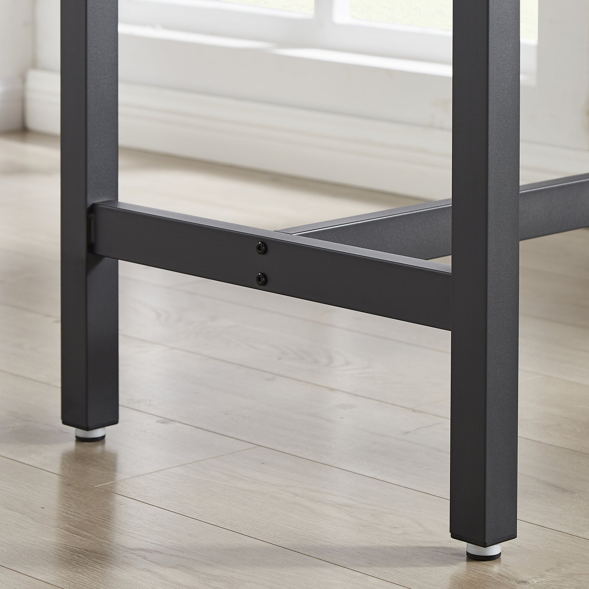 Black metal table leg with adjustable foot