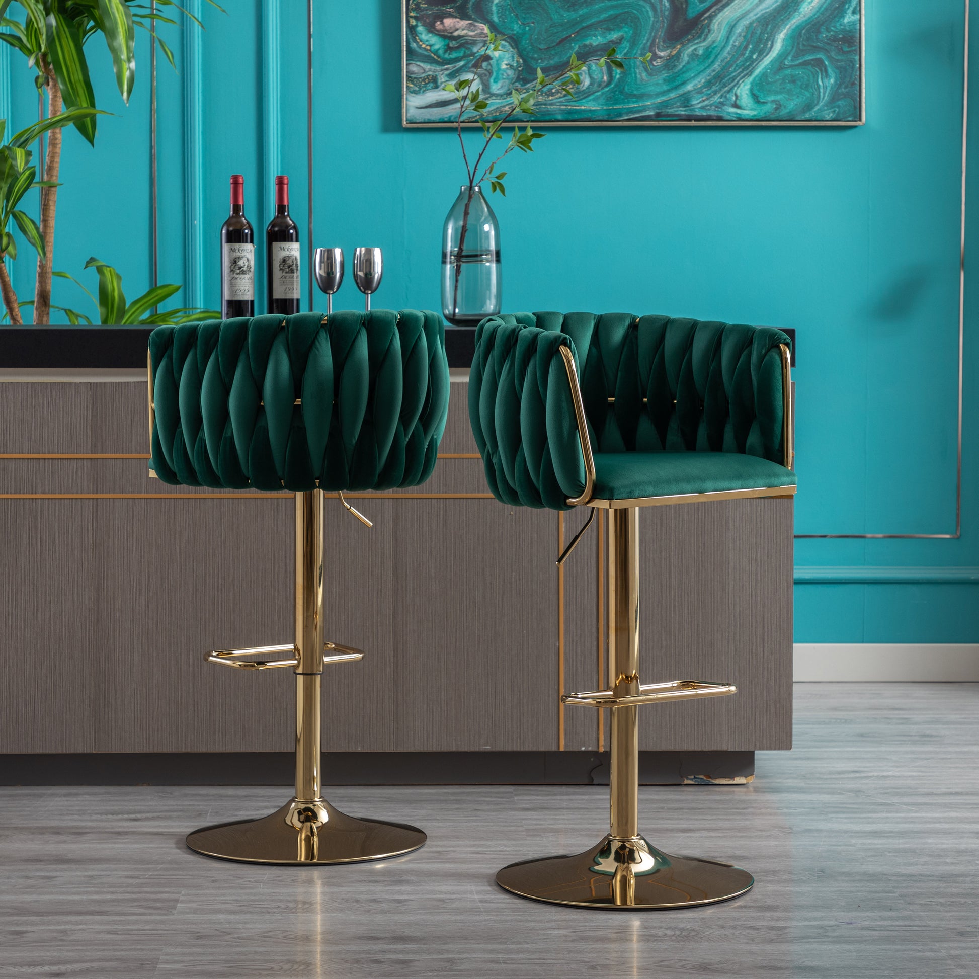 Two plush emerald green velvet bar stools with gold bases