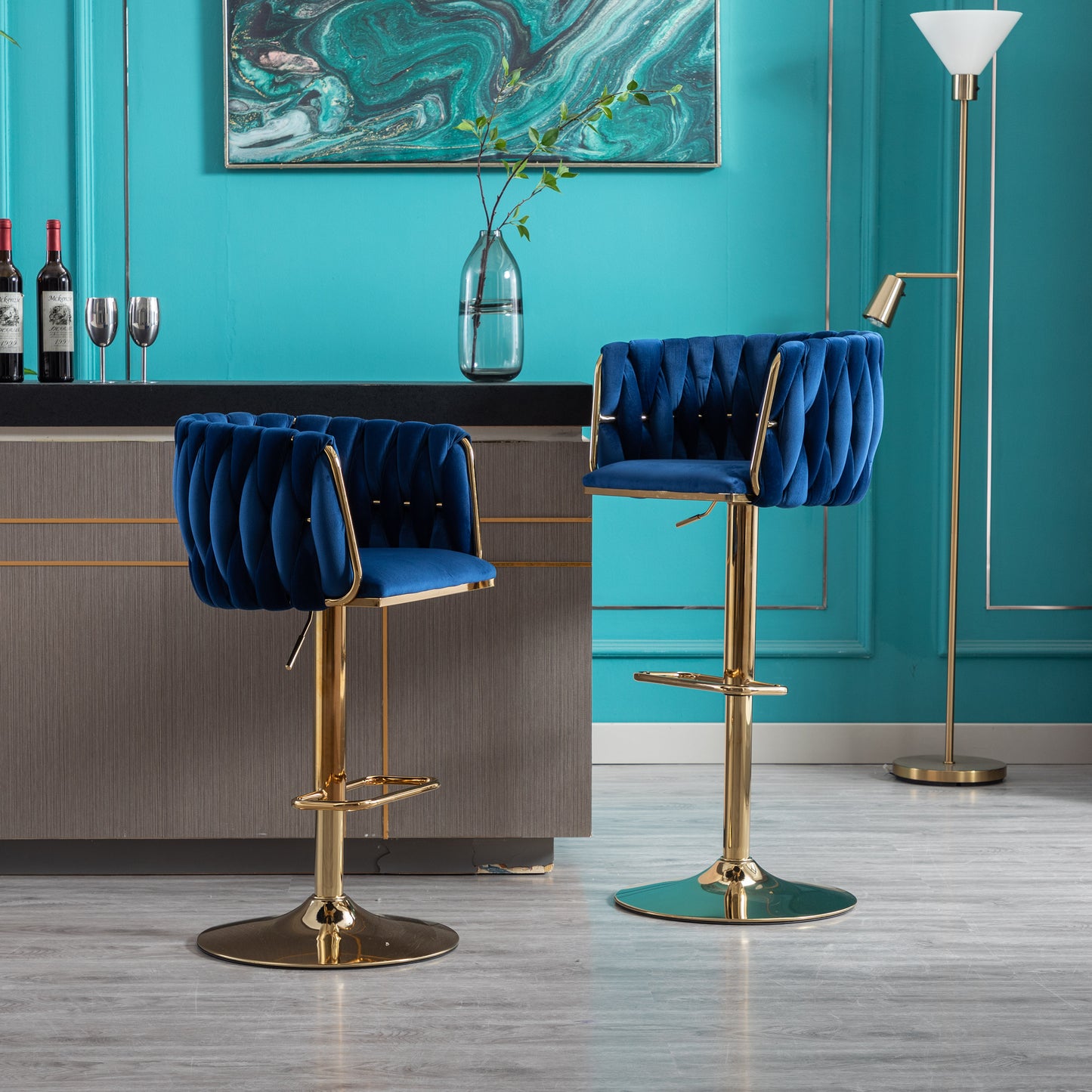 Plush navy velvet bar stool with gold chrome base and tufted back