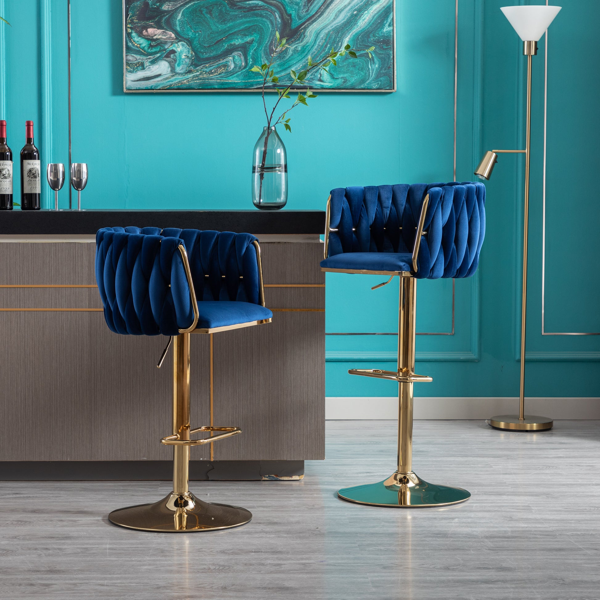 Plush navy velvet bar stool with gold chrome base and tufted back