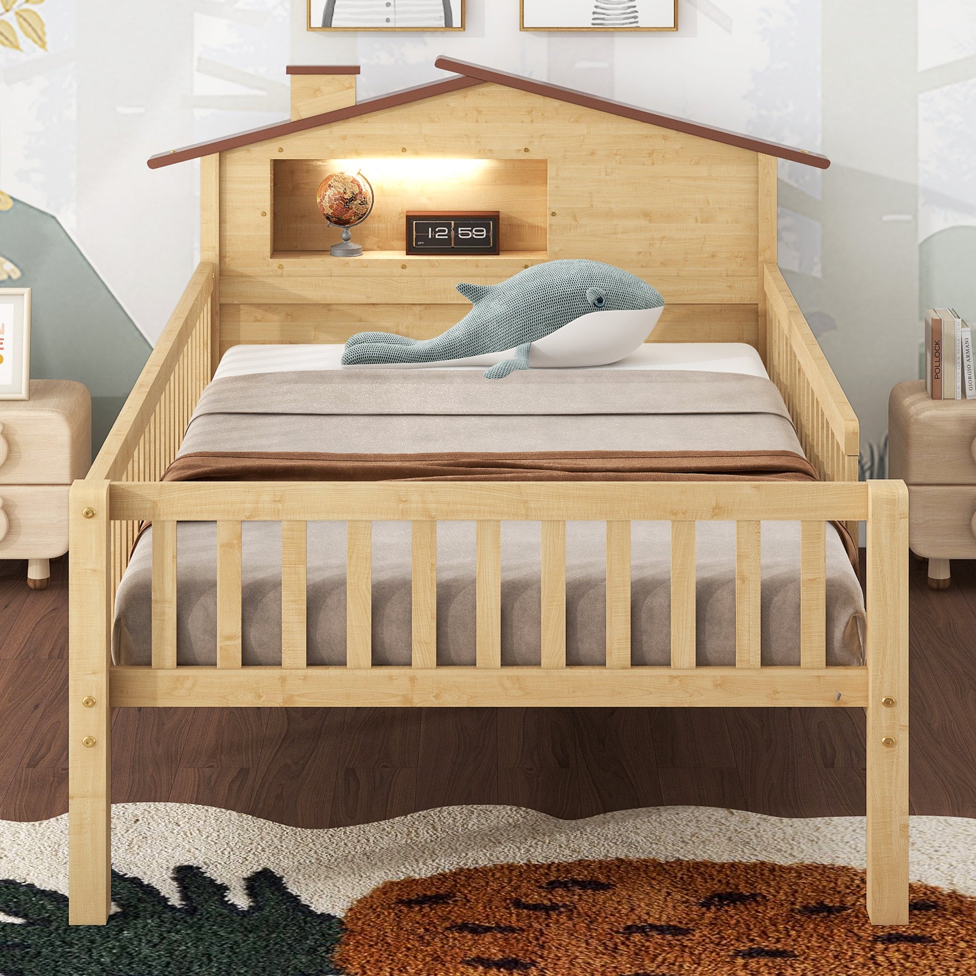Natural wood twin bed with a playful houseshaped headboard and whale plush
