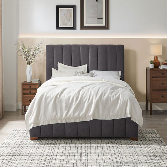 Dark grey upholstered platform bed with tufted headboard and white bedding