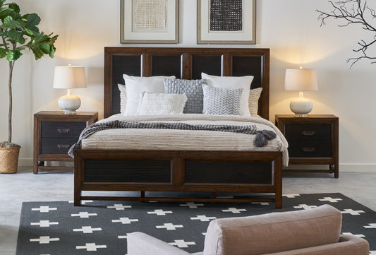 Dark wood platform bed with slatted headboard and textured bedding