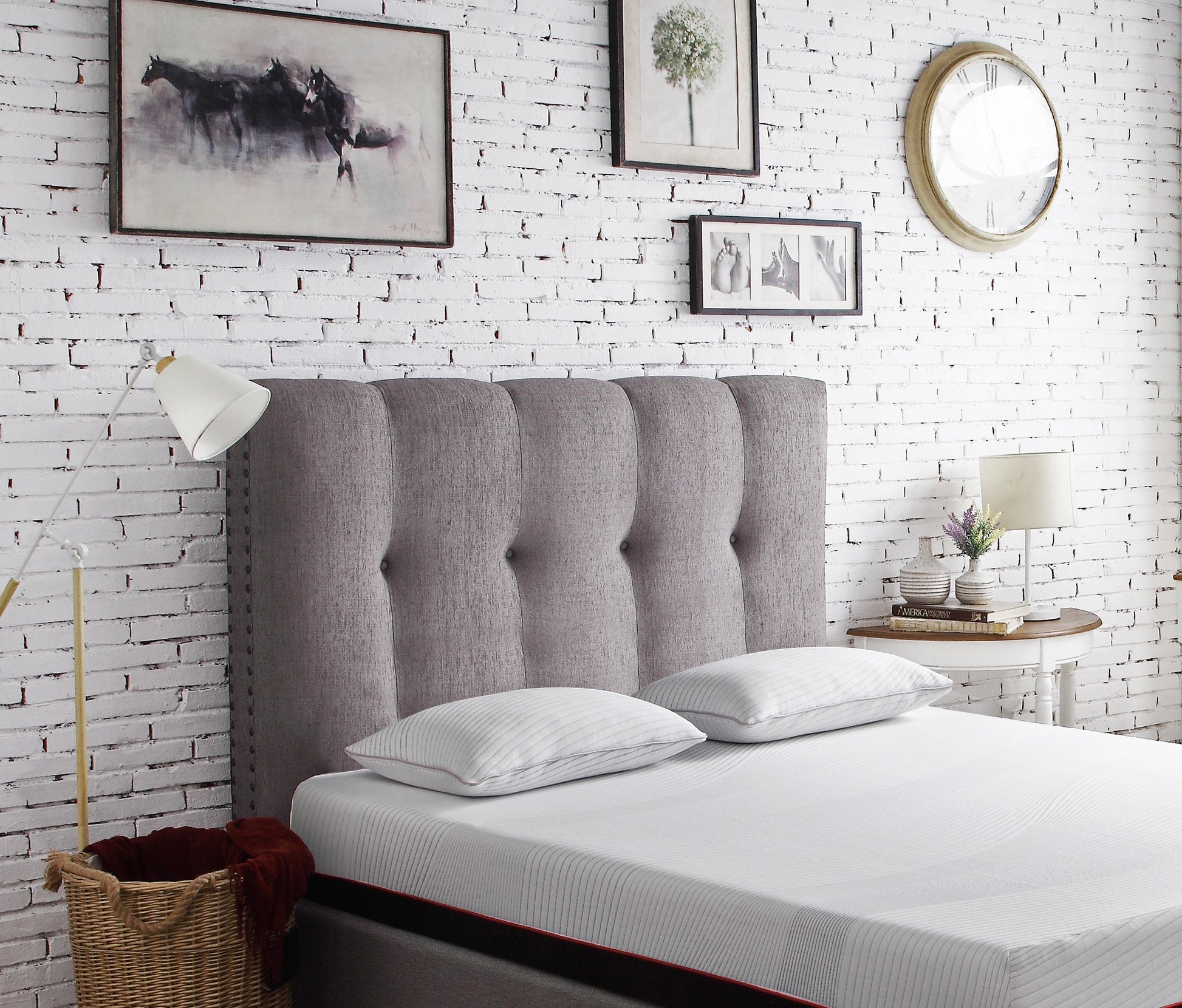 Tufted grey fabric headboard with silver nailhead trim suitable for a queen size bed