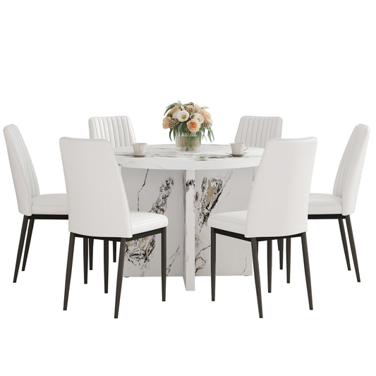 White upholstered dining chairs surround a white marble pedestal dining table with floral centerpiece