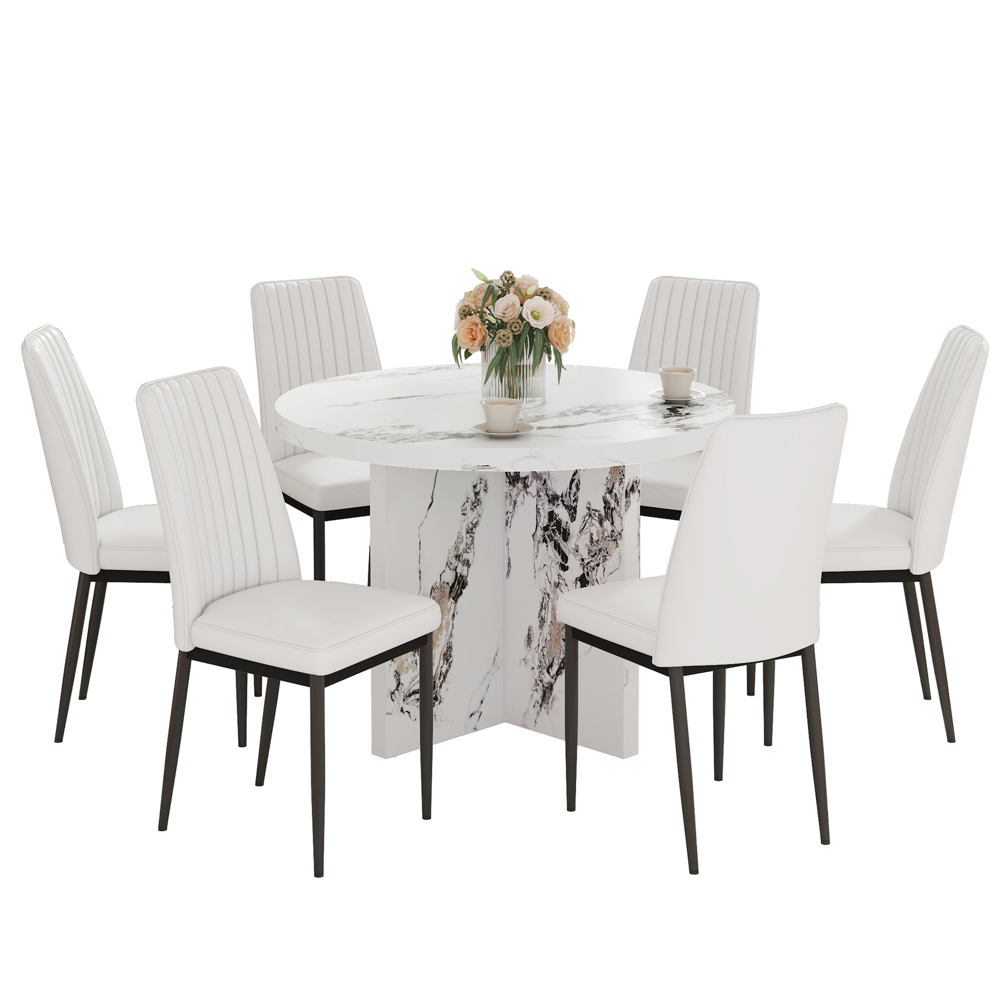White upholstered dining chairs with a fluted back design surrounding a marble pedestal dining table with floral centerpiece