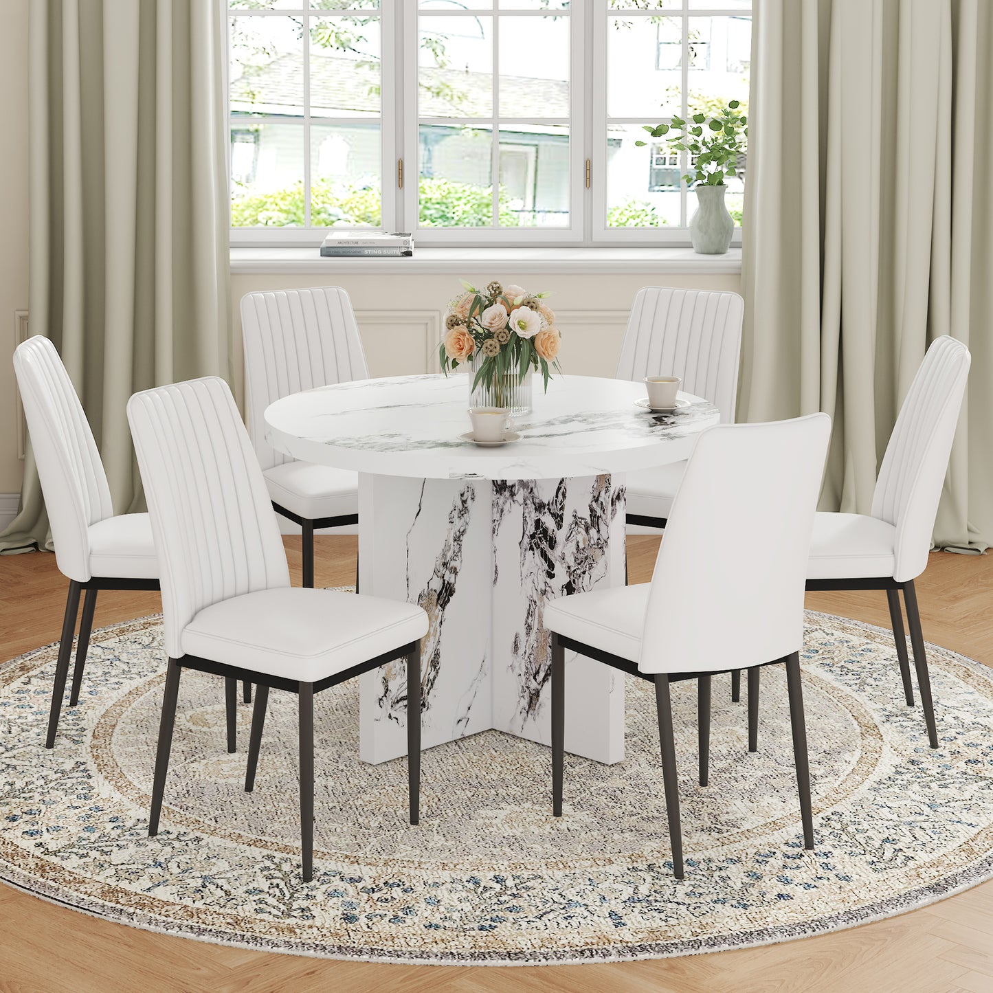 Round marble dining table with six white tufted chairs