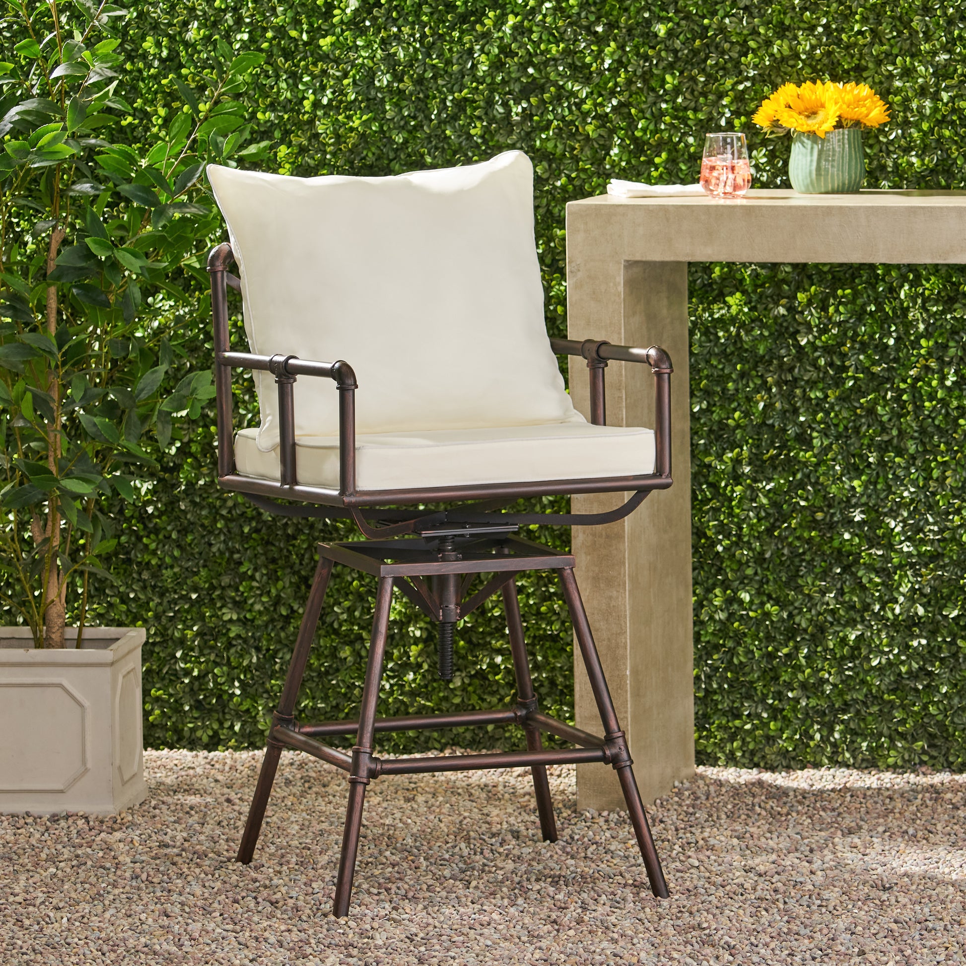 Rustic bronze metal swivel bar stool with cream cushions