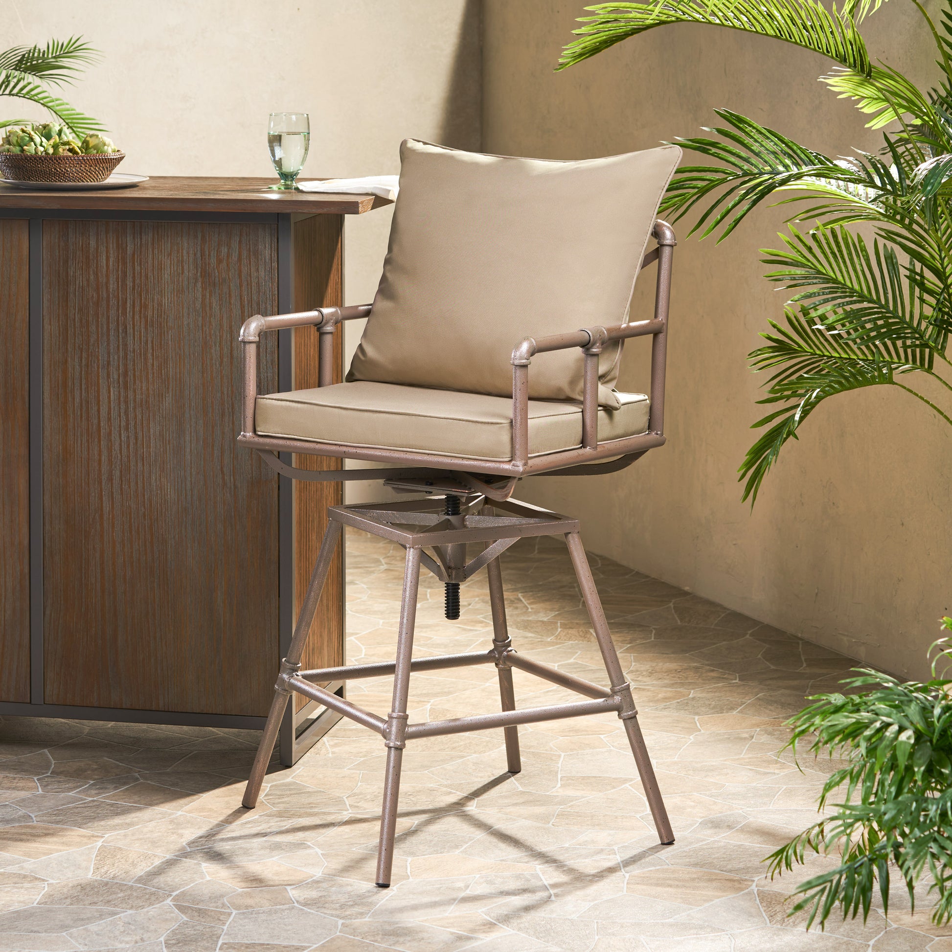 Tan cushioned metal bar stool with adjustable height