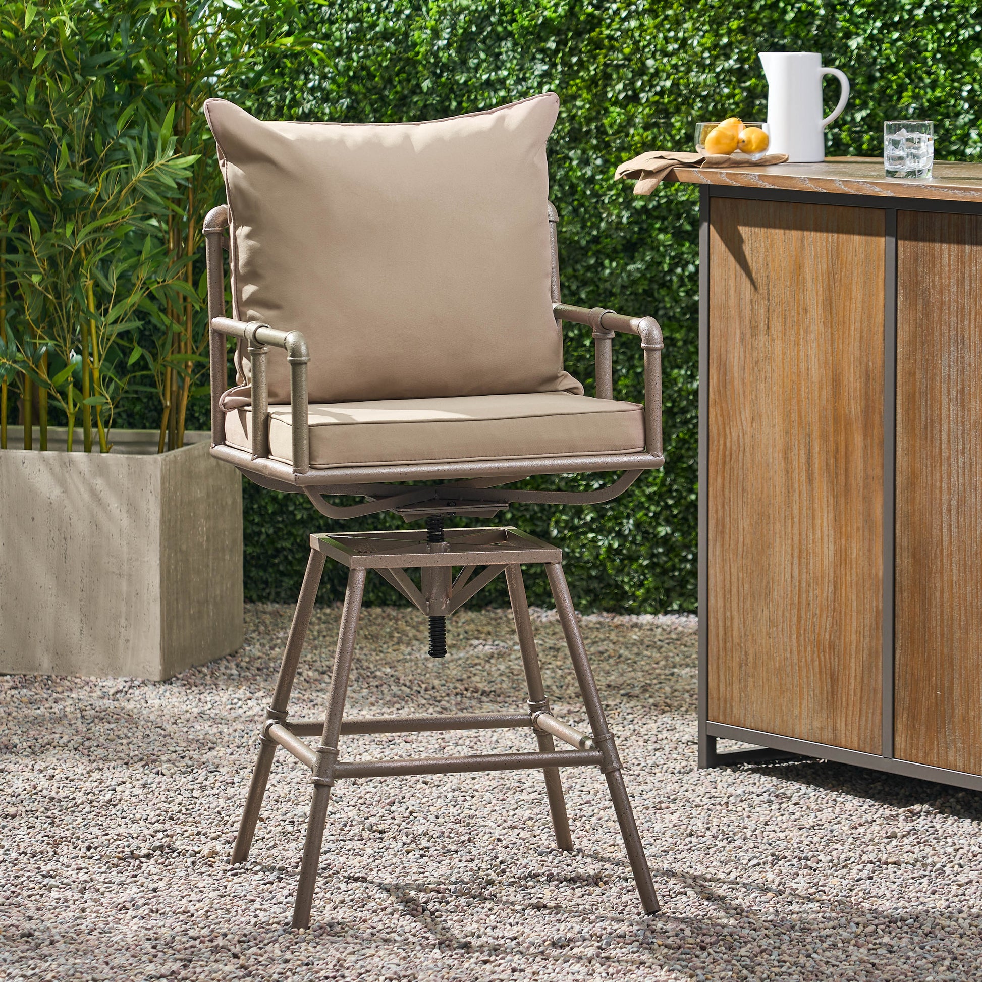 Swivel outdoor bar stool with taupe cushions and a sturdy metal frame
