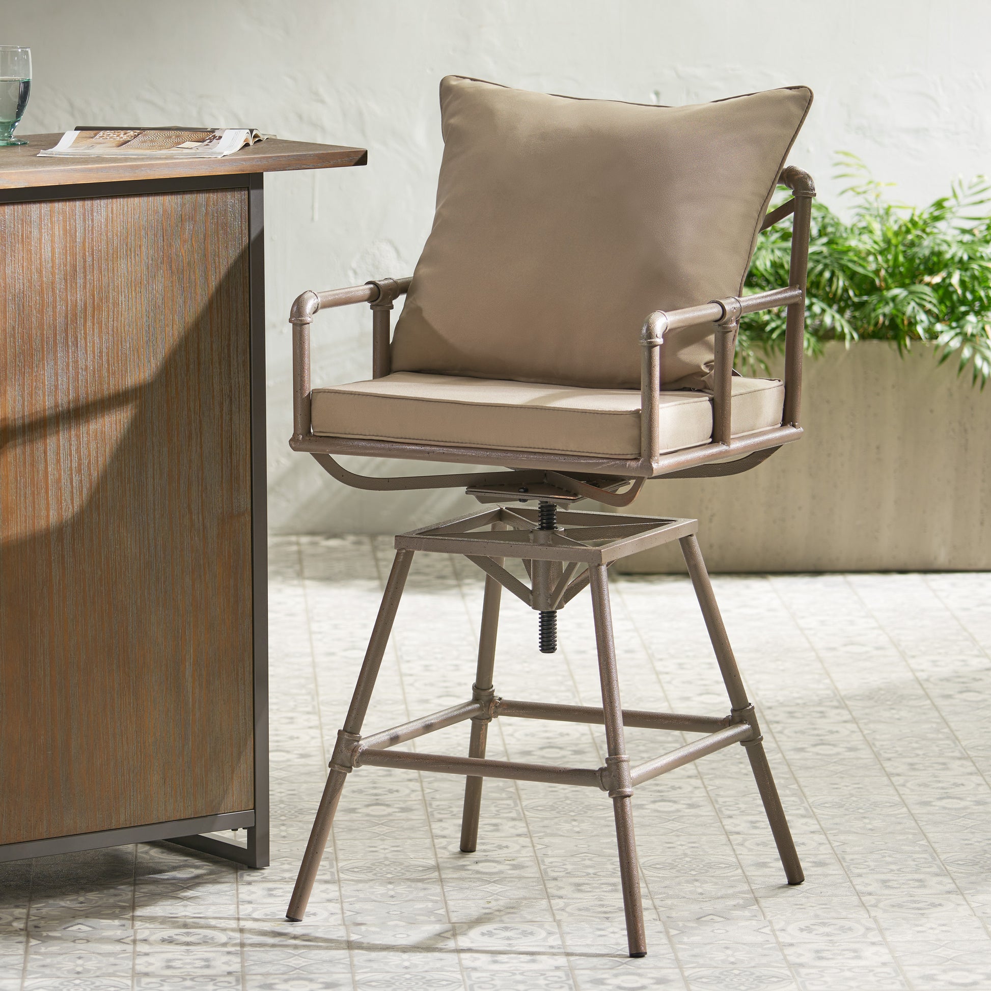 Adjustable height swivel bar stool with taupe cushions and distressed metal frame