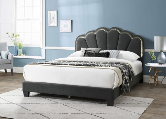 Dark gray upholstered king bed with scalloped headboard