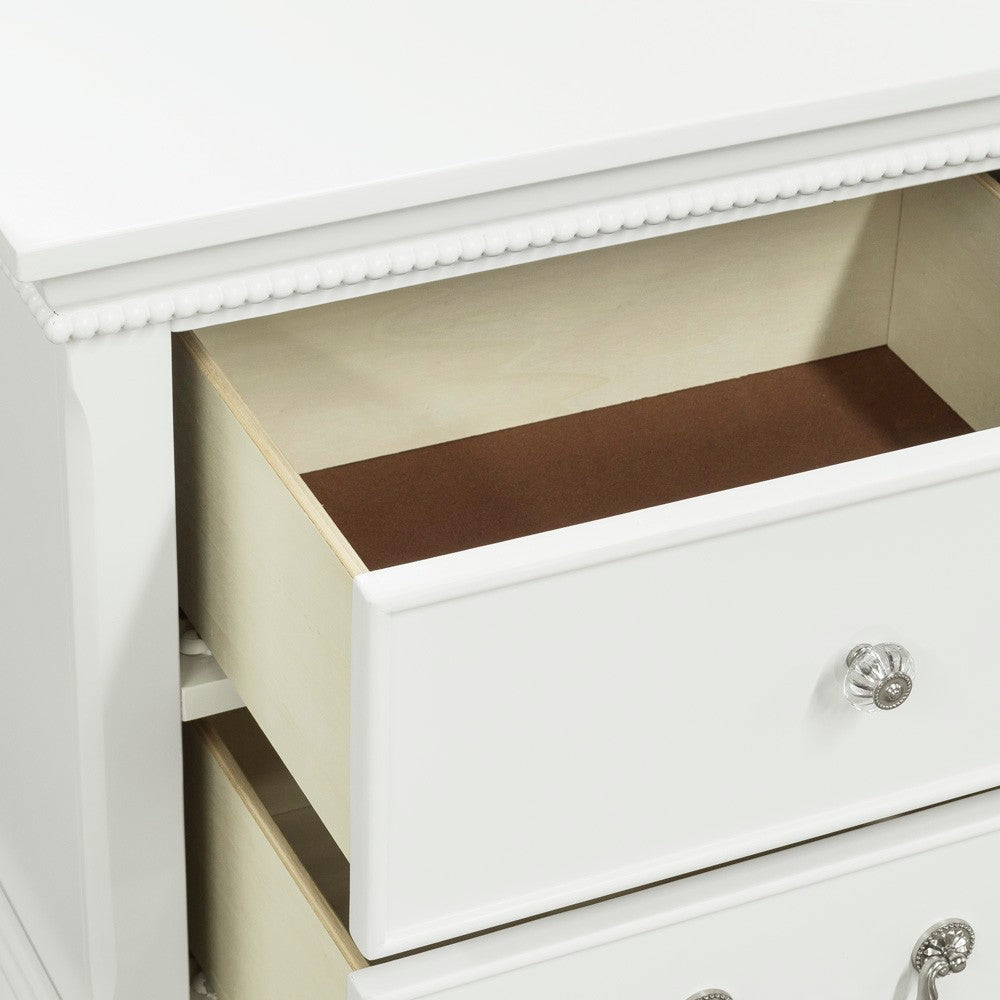White dresser with ornate beaded trim and clear crystal knobs