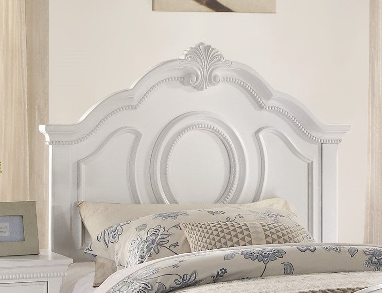 White carved headboard with oval inset and bead trim