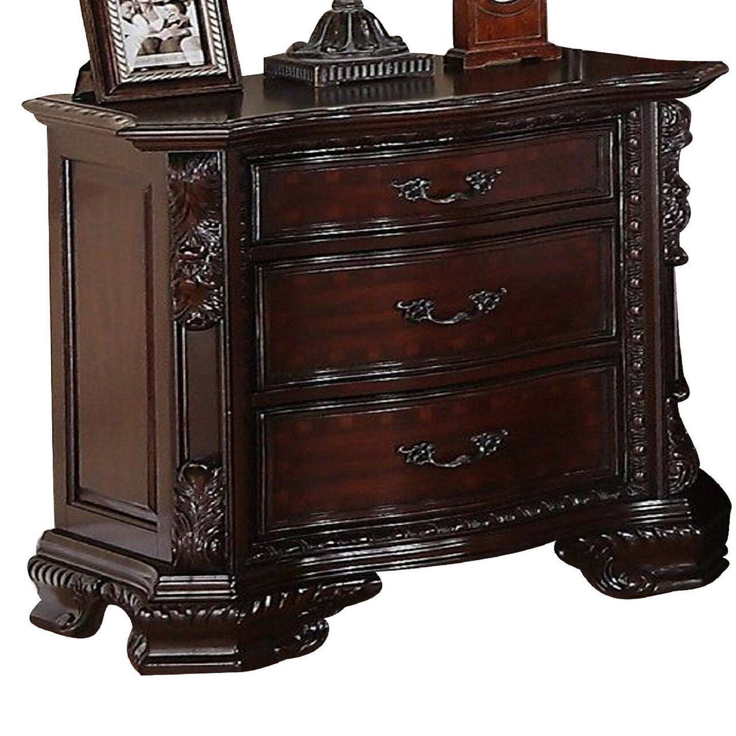 Dark cherry wood nightstand with three drawers and ornate carving