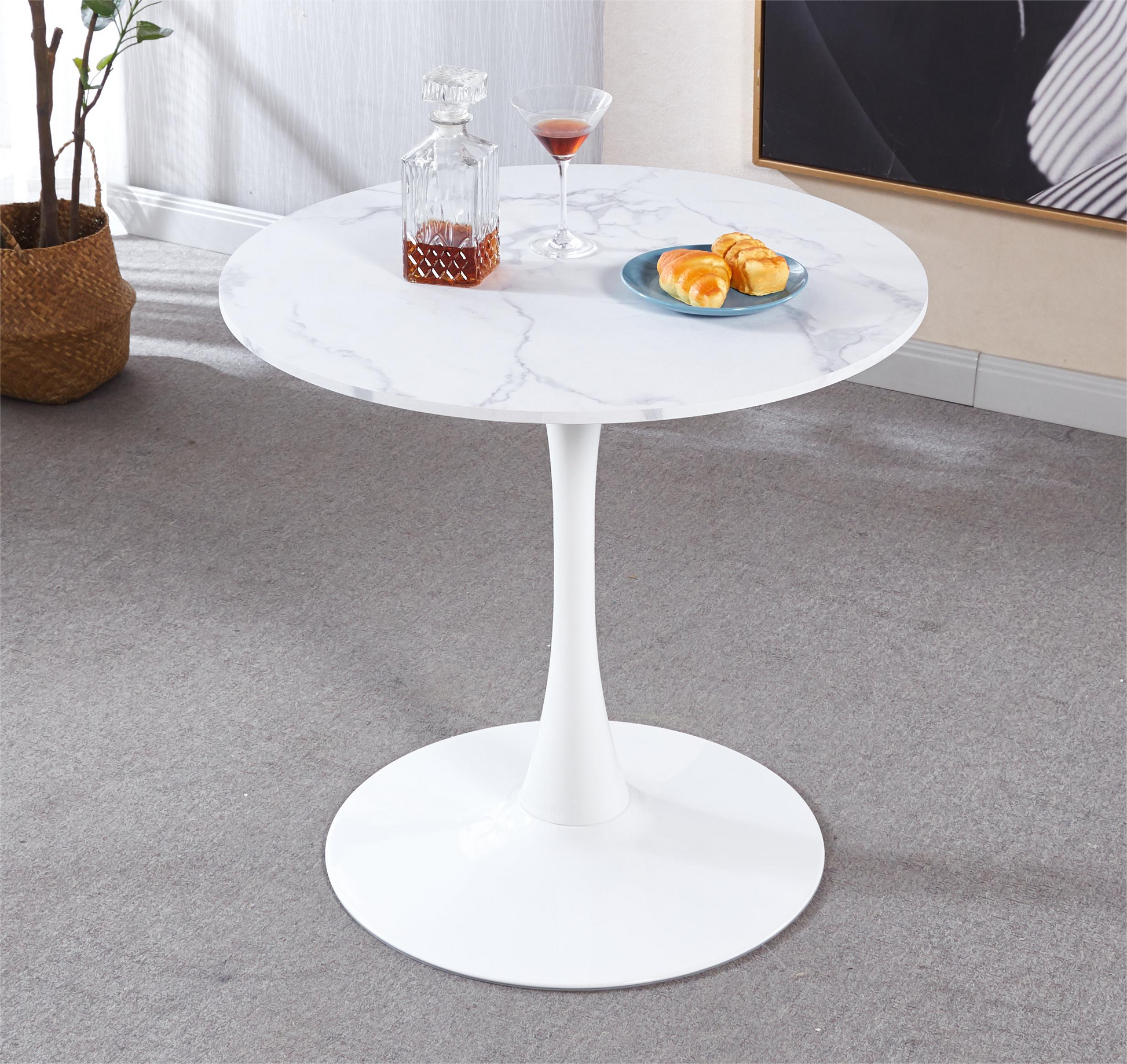 White marble tulip dining table with a single pedestal base and brushed metal finish