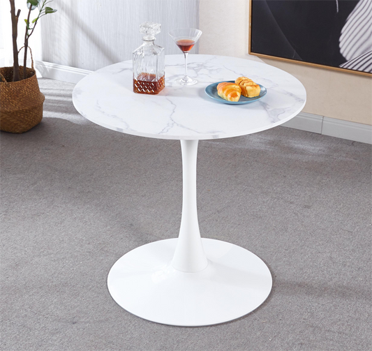 White marble tulip dining table with a single pedestal base and brushed metal finish