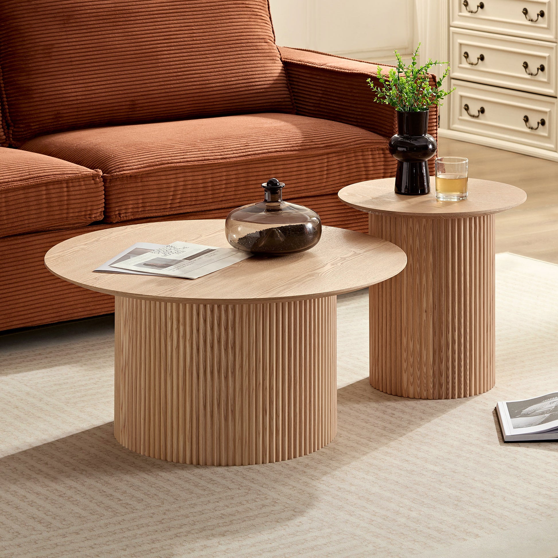 Round fluted wood coffee table with magazines