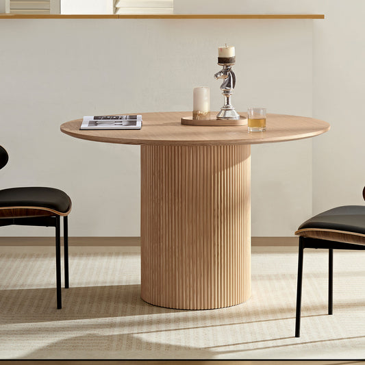 Round oak dining table with fluted pedestal base