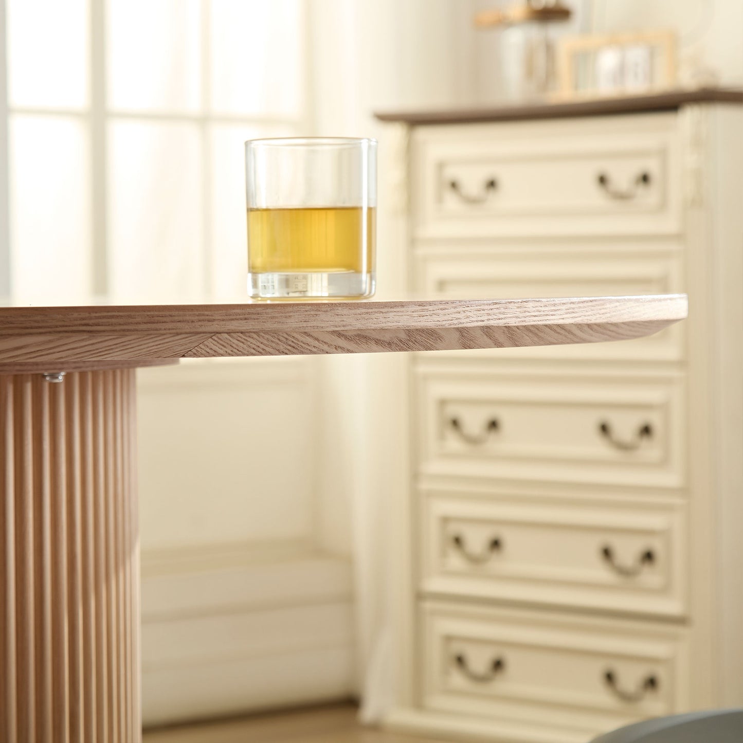 Round wooden dining table with fluted base