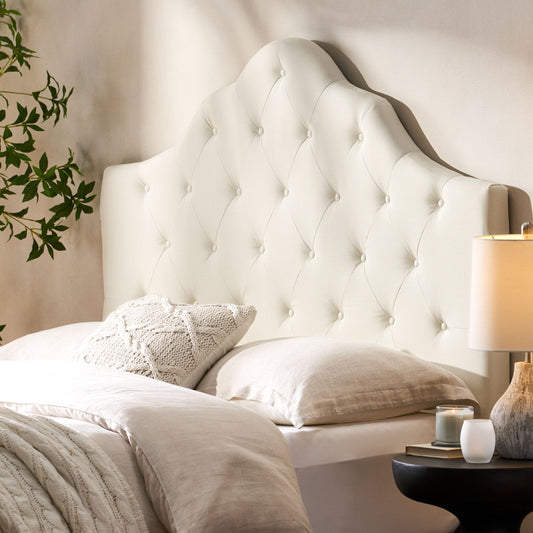Cream upholstered headboard with diamond tufting
