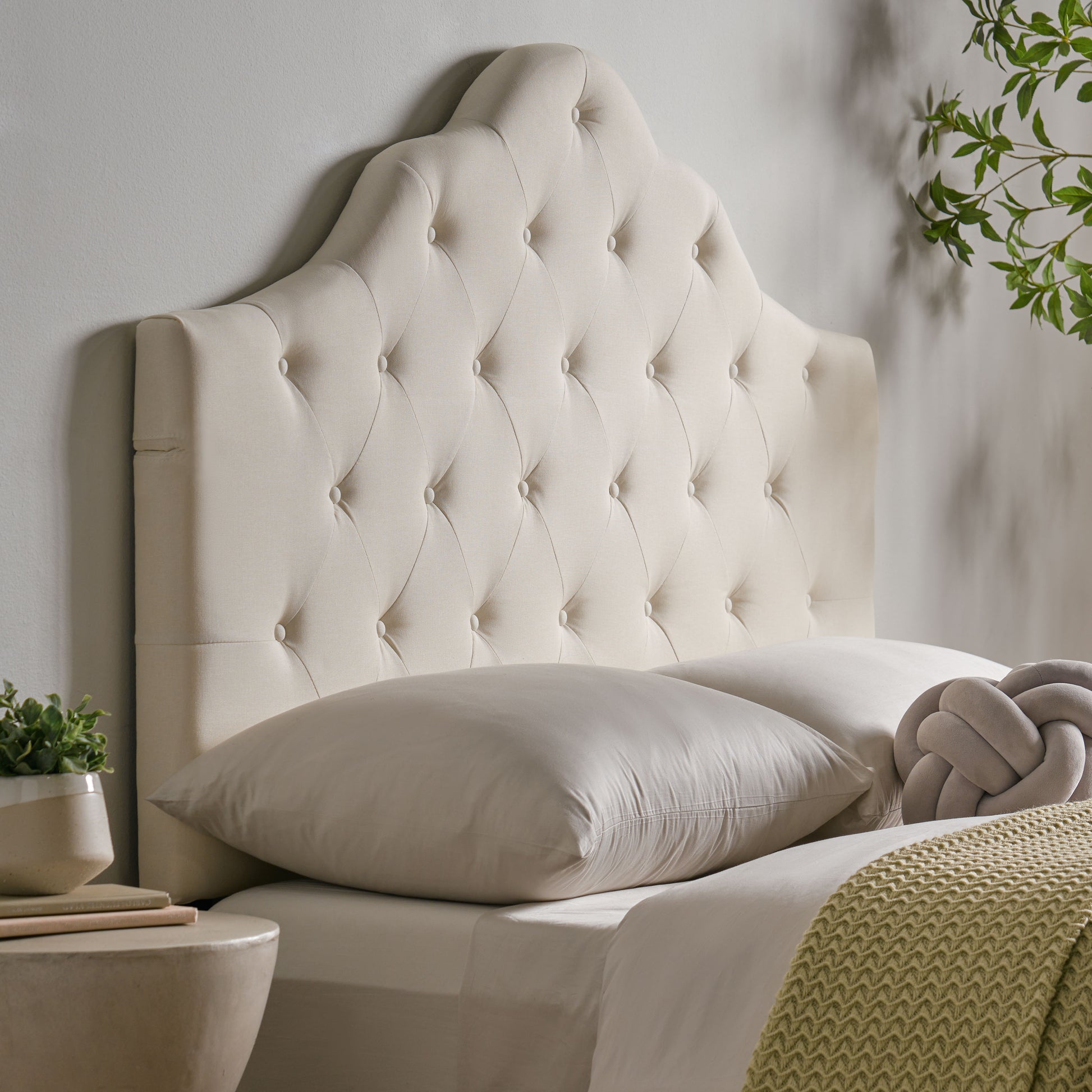 Cream upholstered headboard with diamond tufting