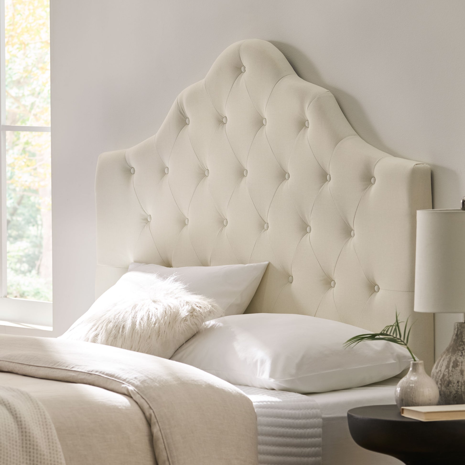 Elegant cream velvet headboard with diamond tufting perfect for a luxurious bedroom