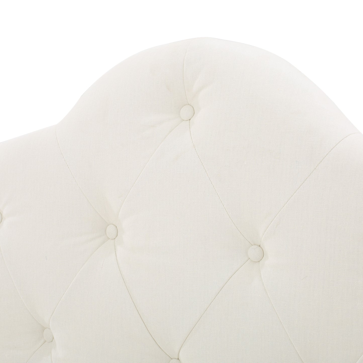 Cream tufted linen upholstery on a headboard with button accents