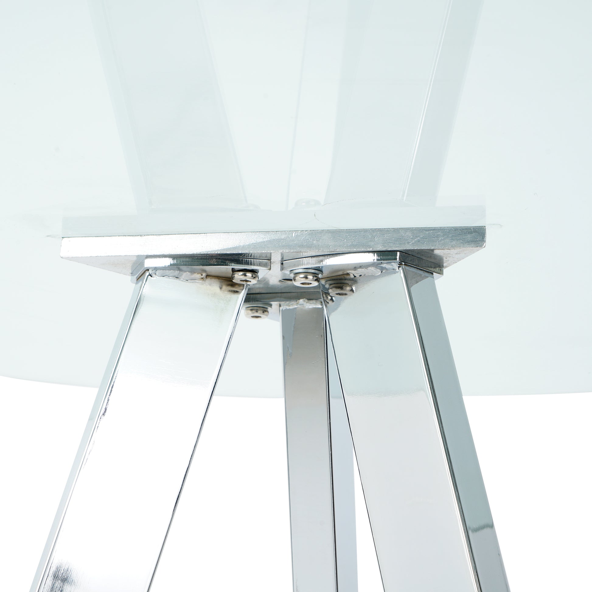 Close up of polished chrome table legs with visible bolts