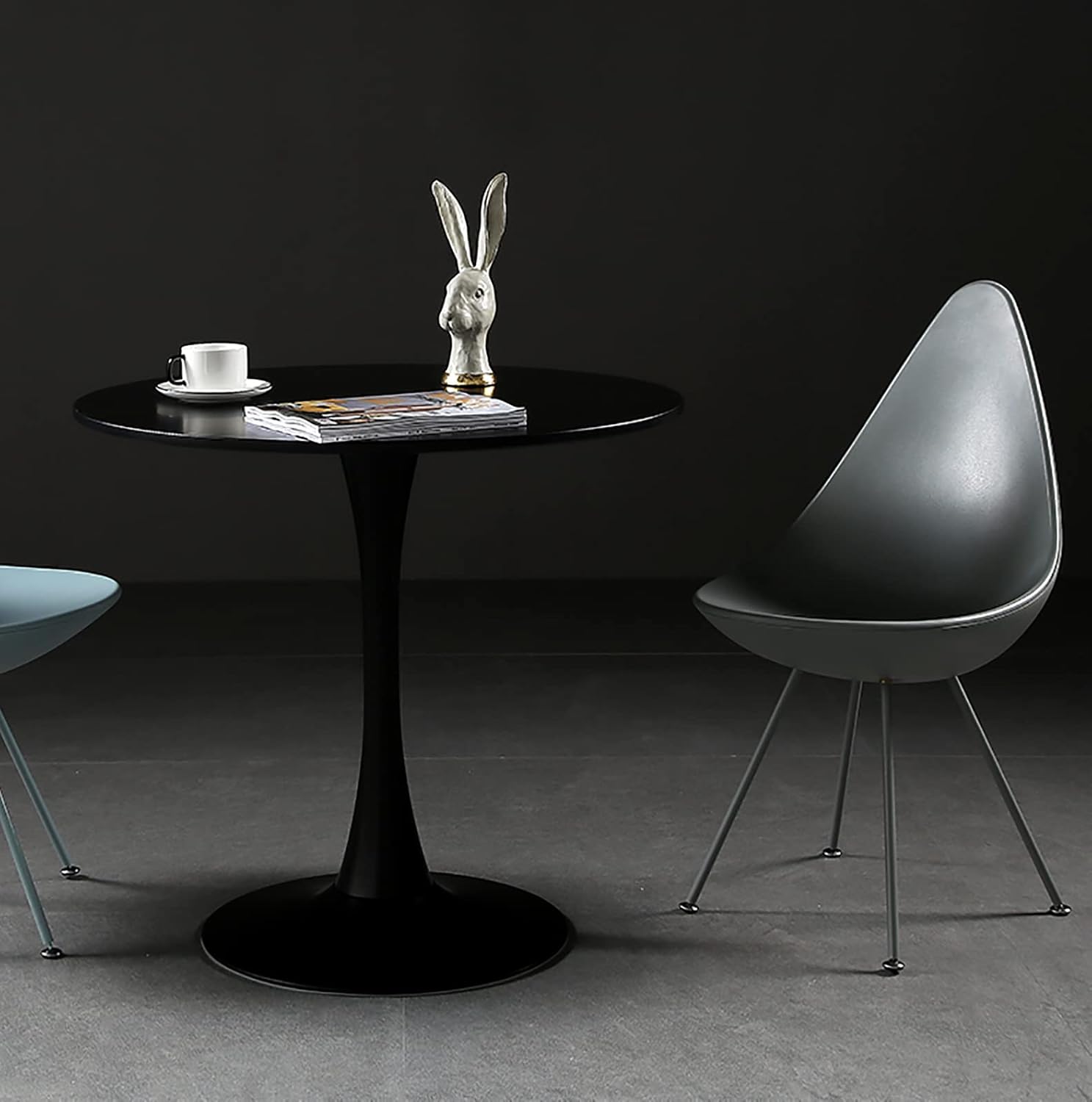 Round black dining table with tulip base perfect for modern kitchens