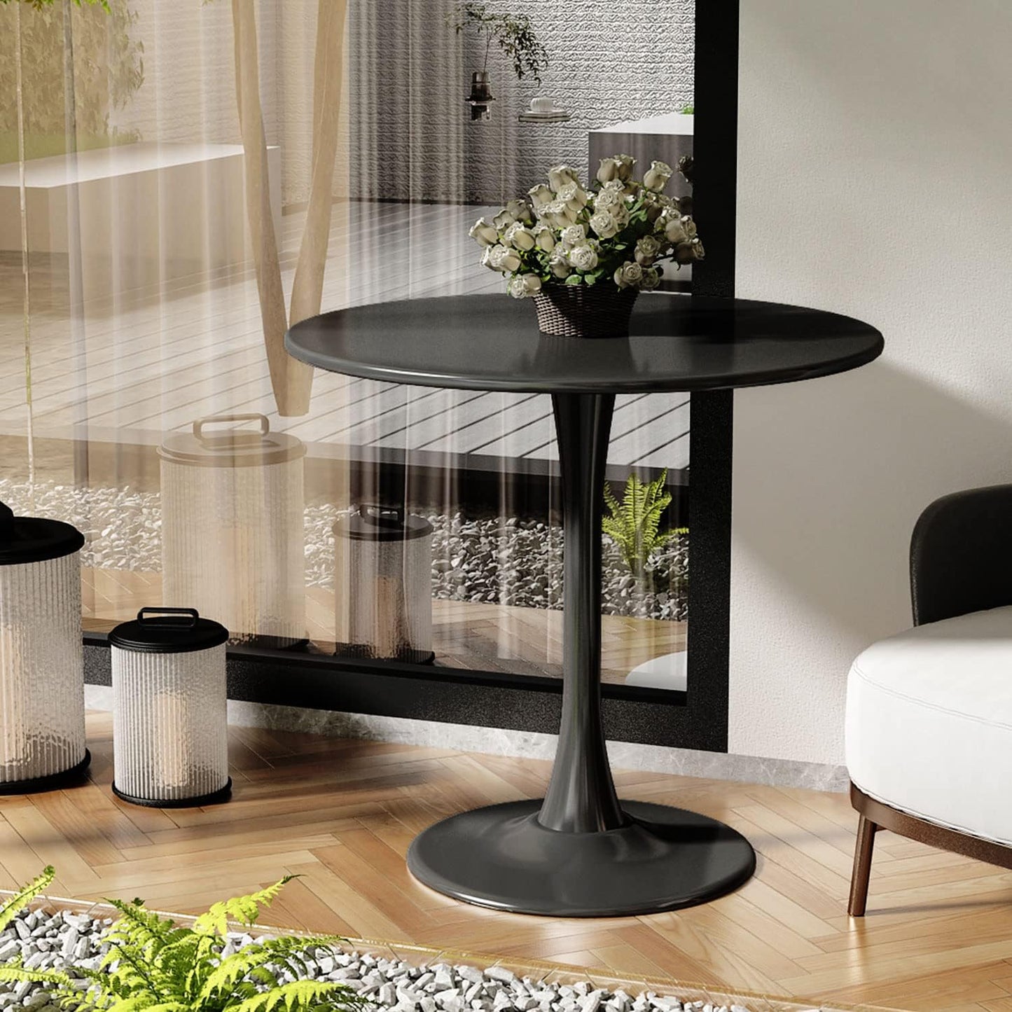 Black tulip pedestal dining table with a basket of white roses