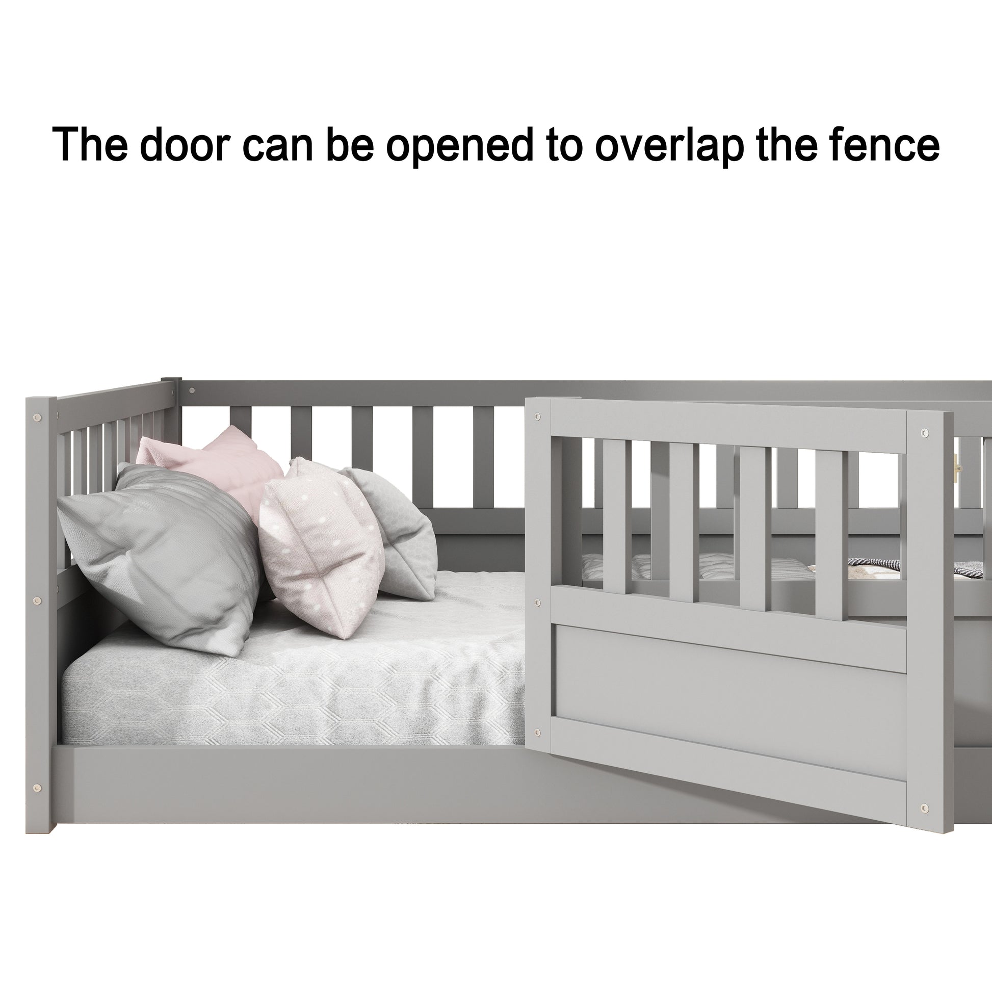 Grey wooden toddler bed with open gate showing soft pillows and a textured blanket