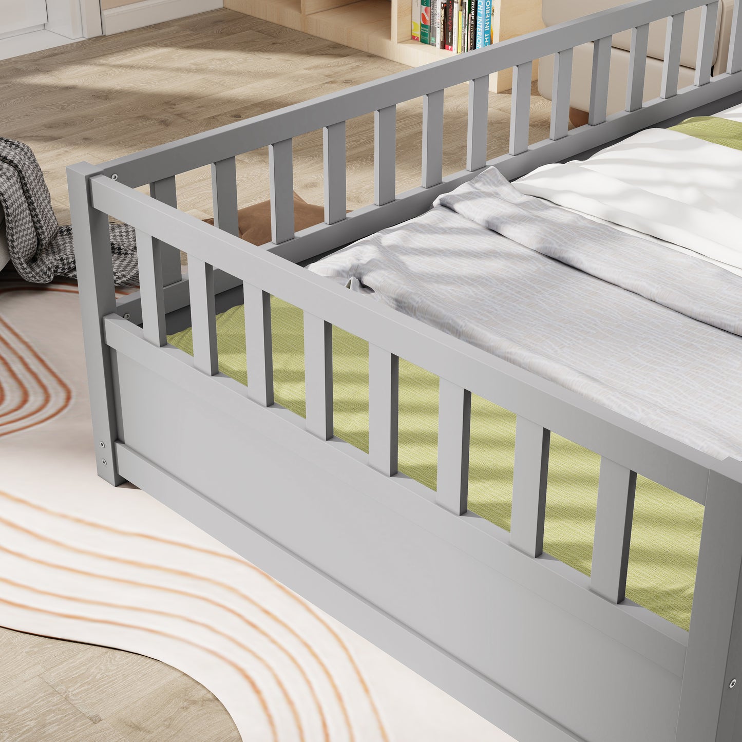 Gray wooden toddler bed with safety rails and white bedding