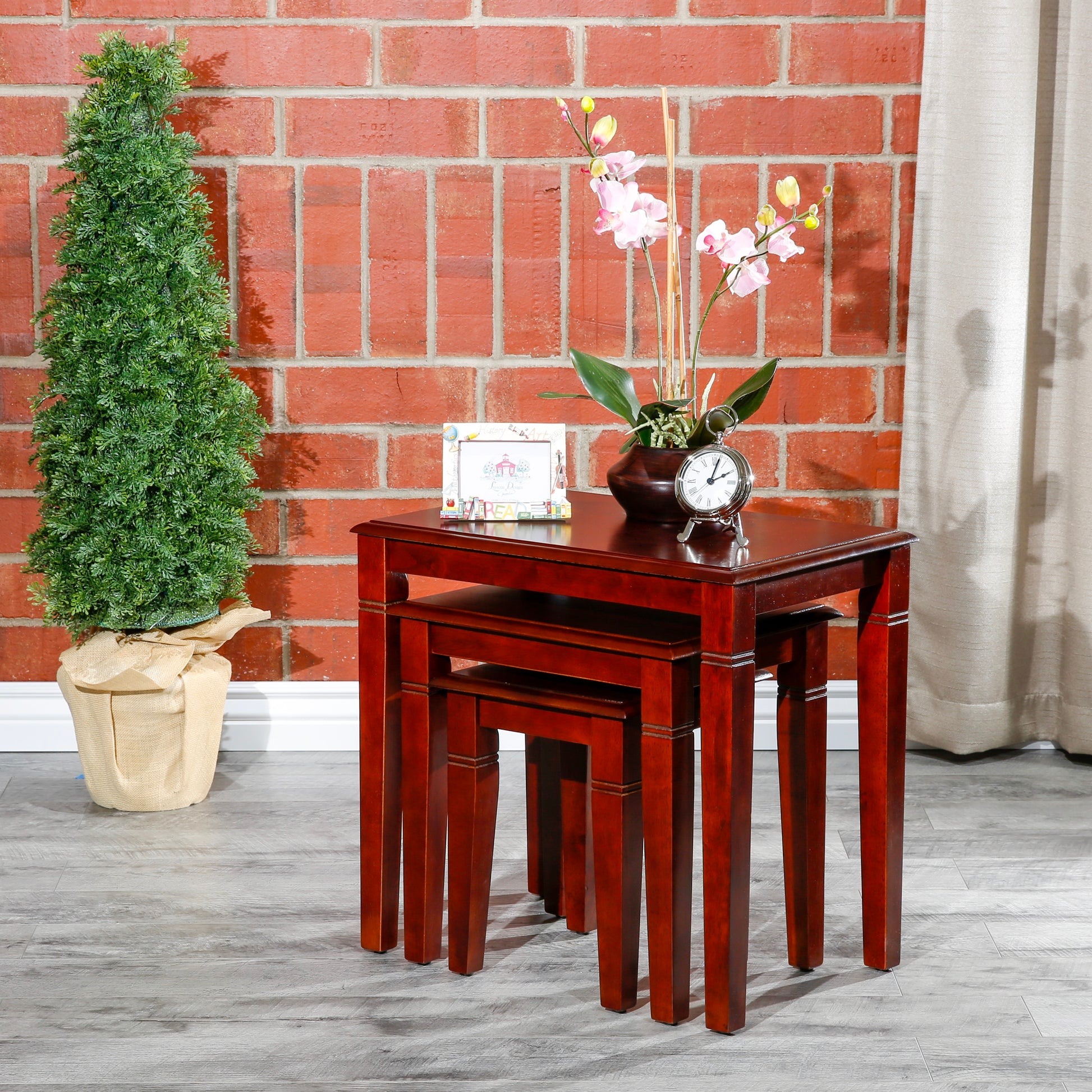 Rich cherry wood nesting tables offer versatile display and storage solutions