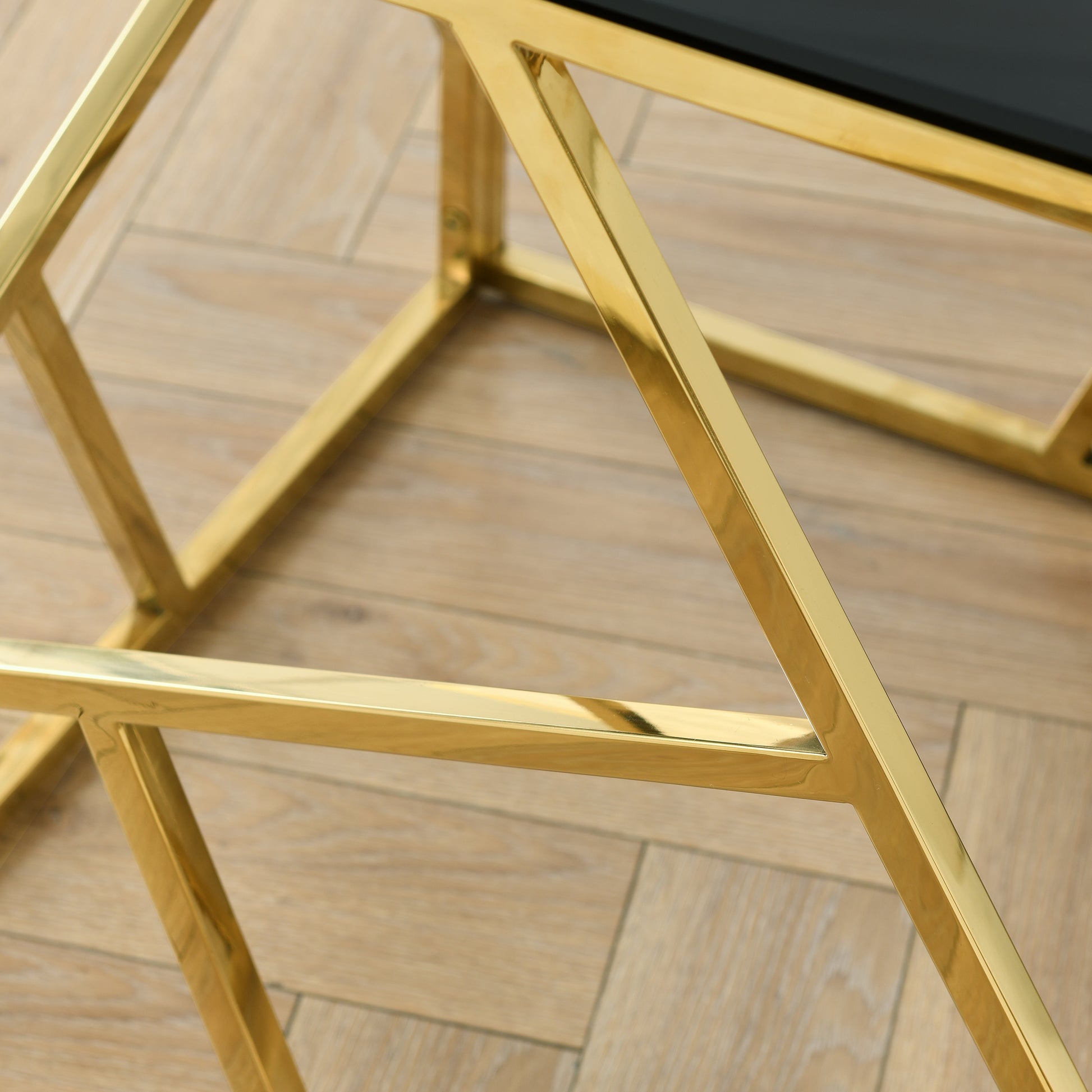 Polished gold metal frame with geometric design part of a modern coffee table