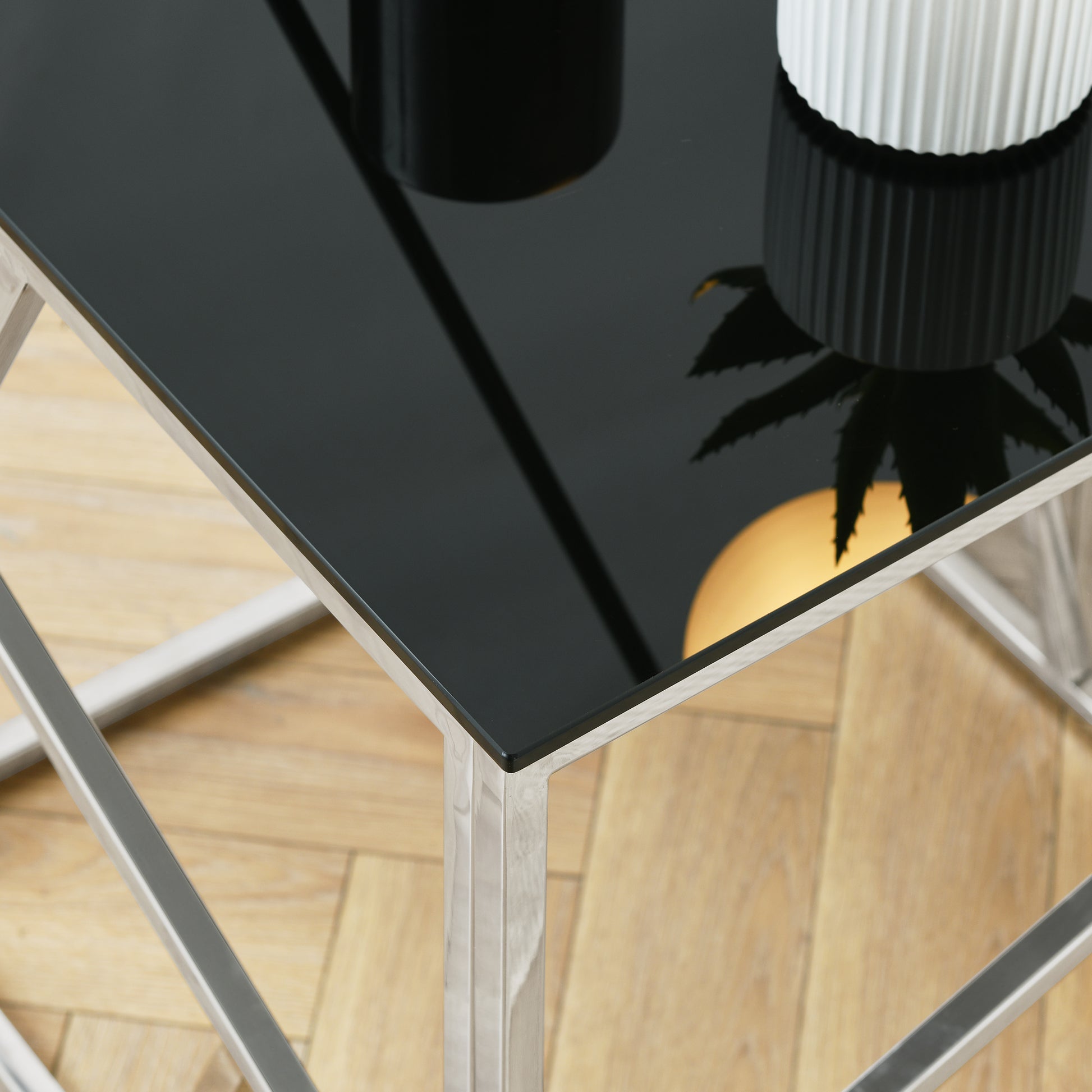 Sleek black glass coffee table with polished chrome frame ideal for modern living rooms