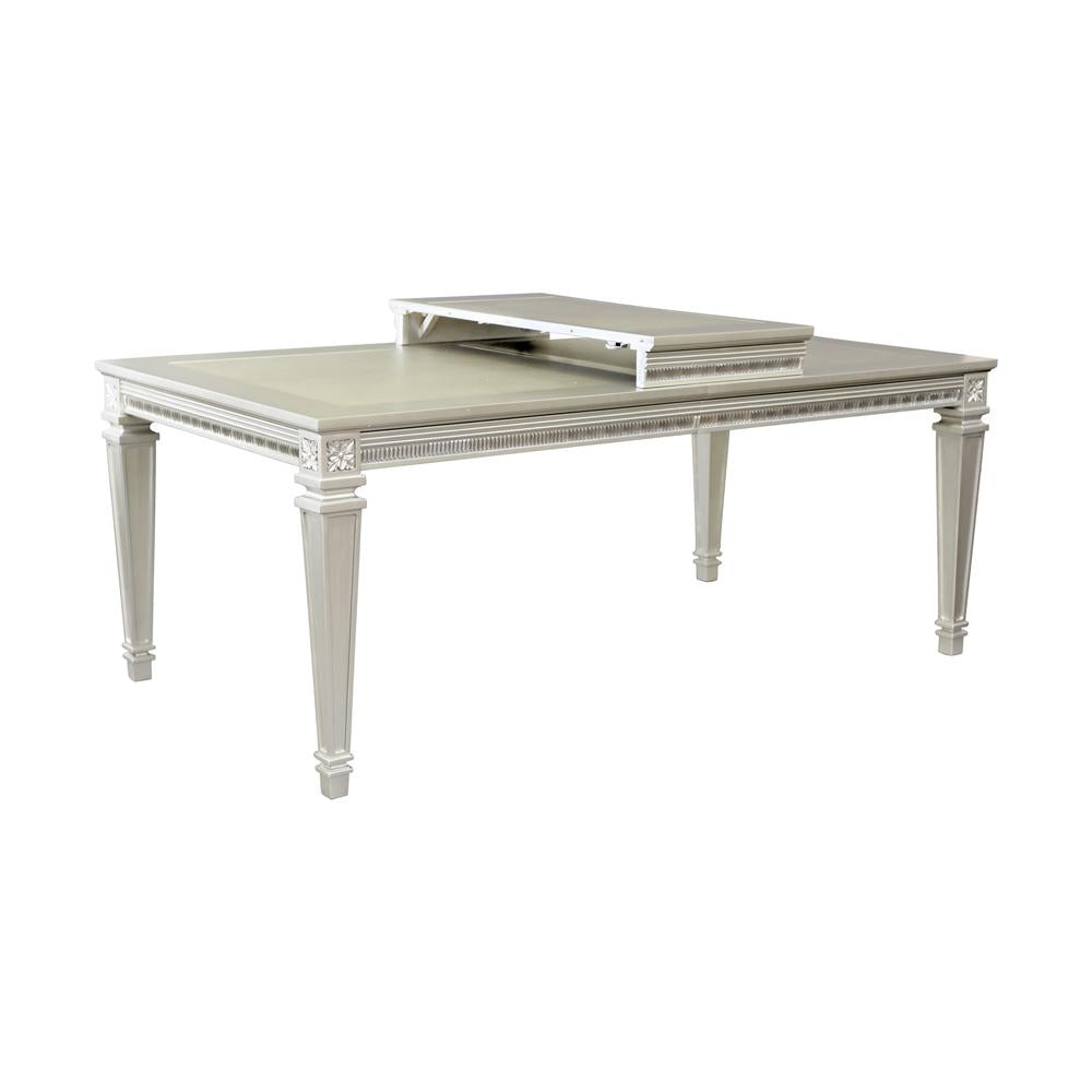 Elegant cream wooden dining table with decorative carvings and a pullout leaf