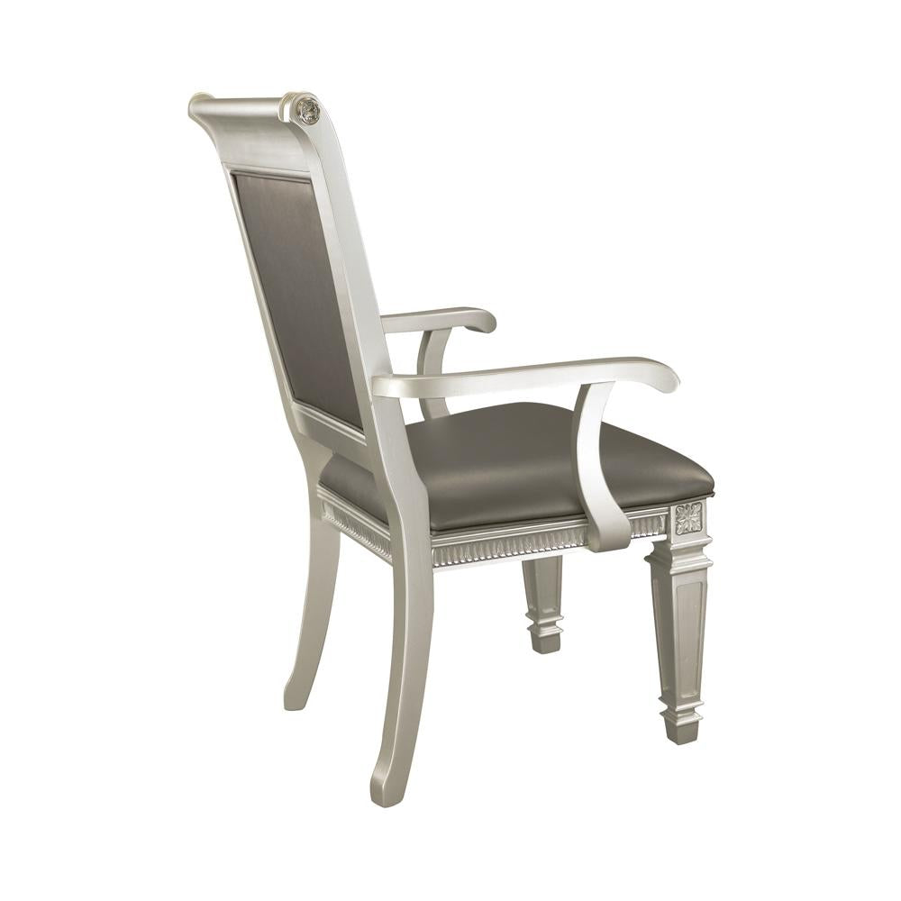 Ornate silver dining chair with dark grey upholstered seat and back