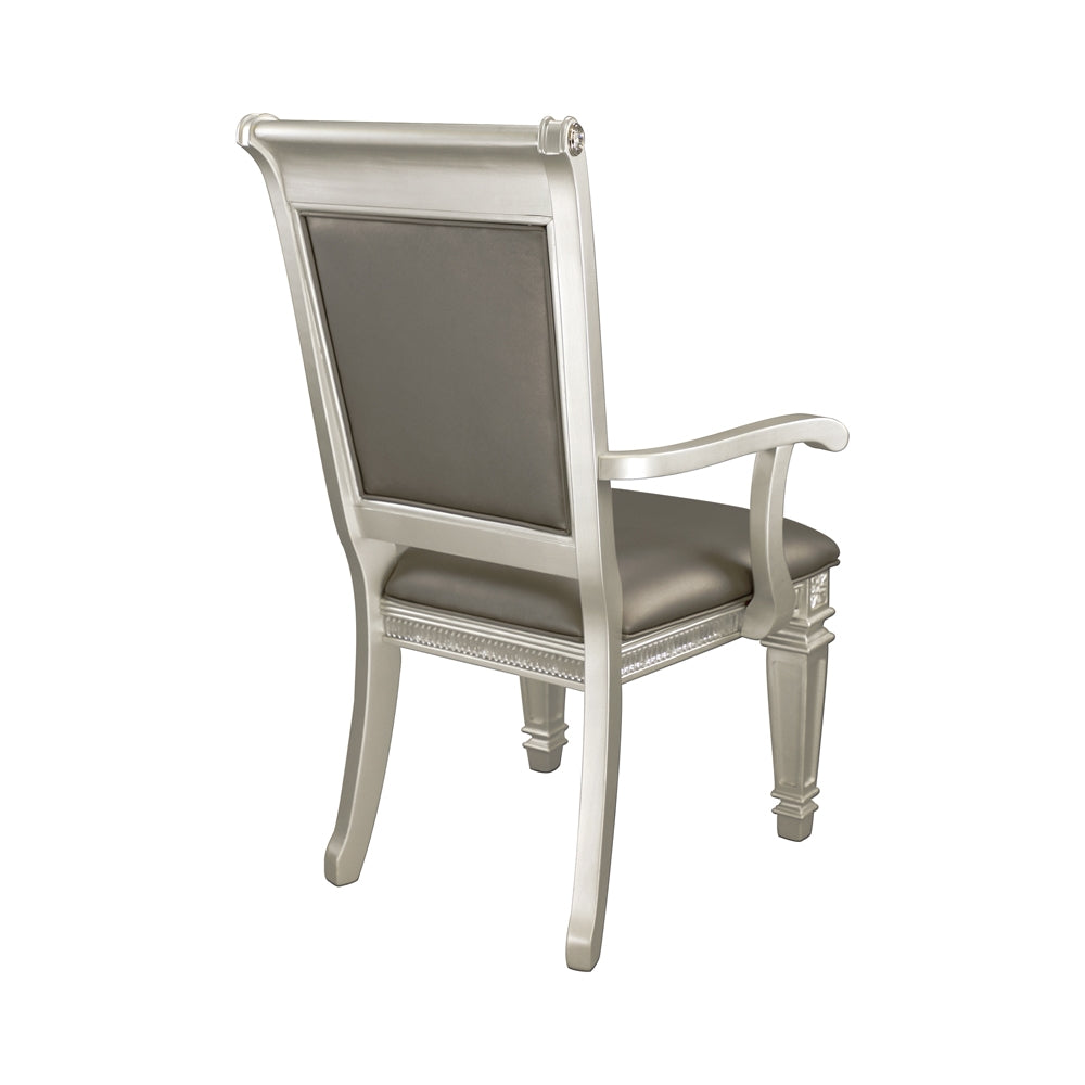 Silver upholstered dining chair with carved details