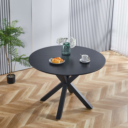 Modern black round dining table with a geometric base ideal for compact spaces