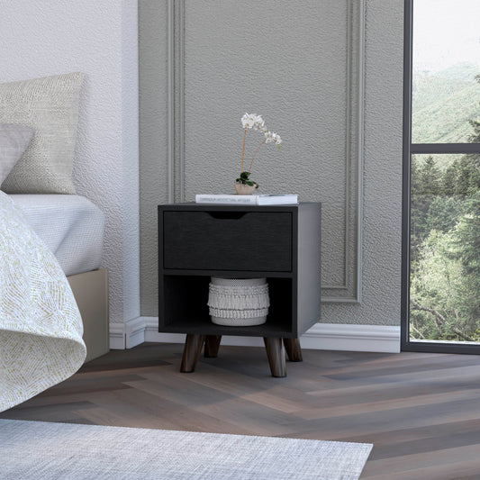 Black modern nightstand with one drawer and open shelf set next to a bed