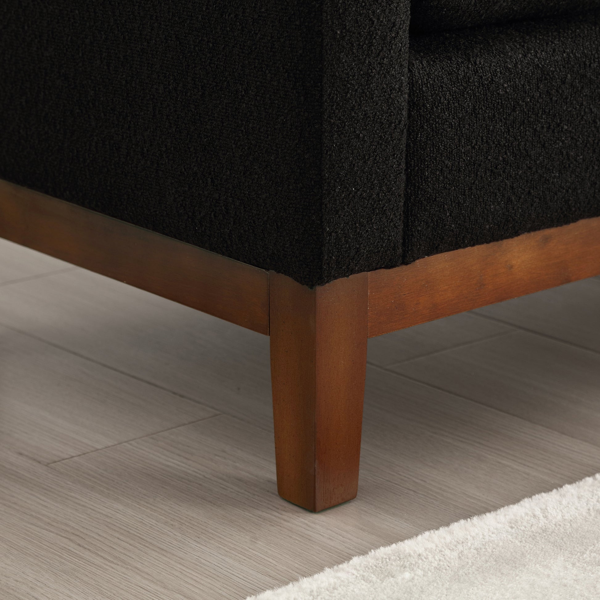 Black boucl fabric armchair armrest detail