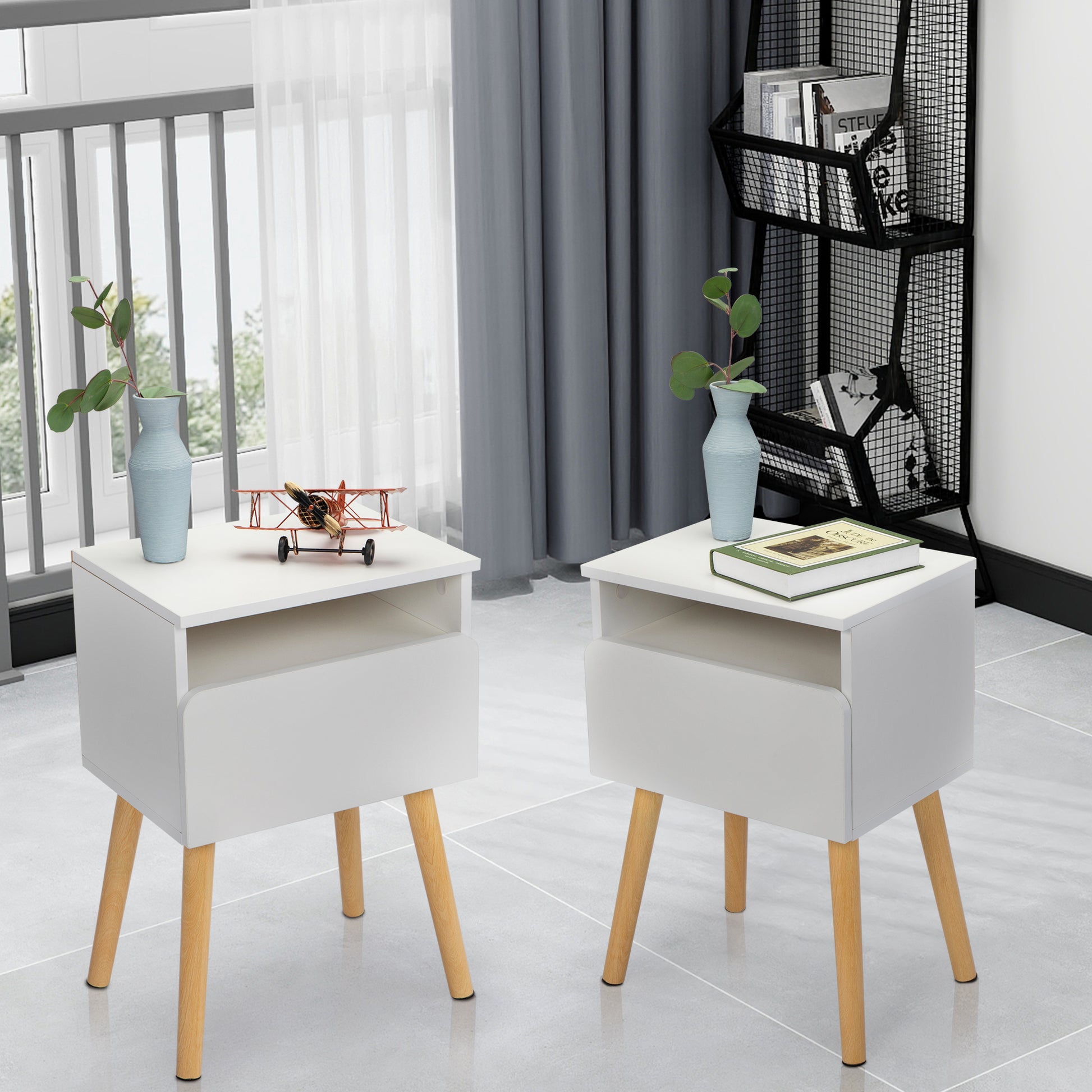 White twodrawer nightstand with tapered wooden legs and open shelf